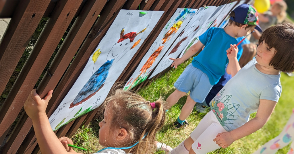 dzieci malując farbami na wolnym powietrzu